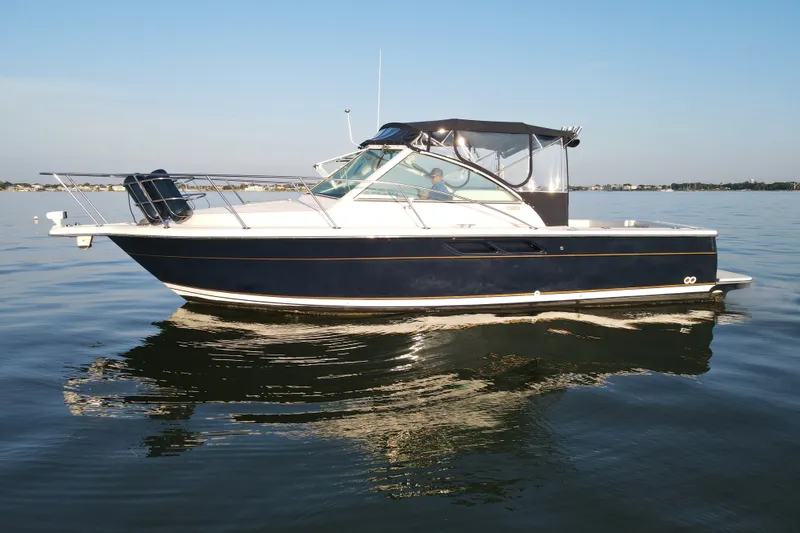 Slide: The Image of 2003 Tiara Yachts 2900 Coronet cruising on calm waters under clear skies. - 8