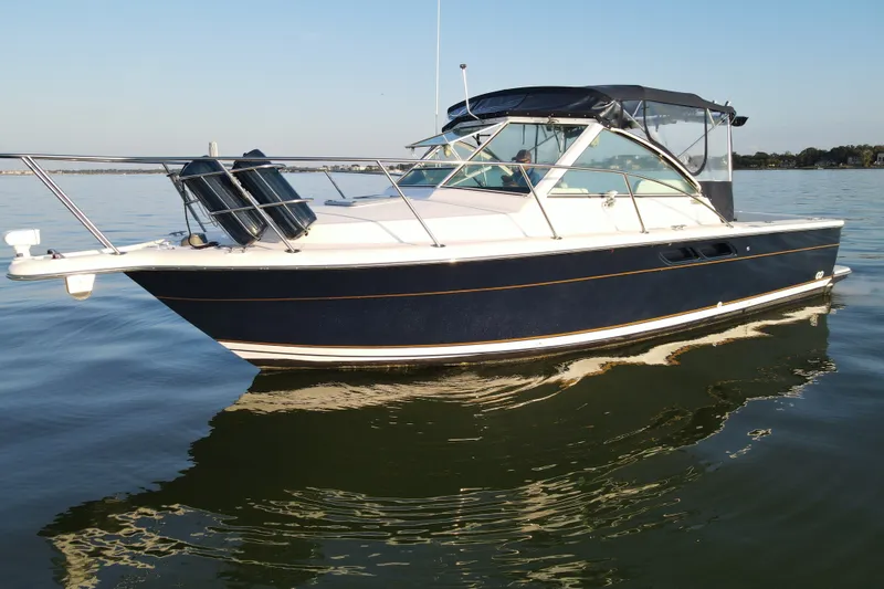 Slide: The Image of 2003 Tiara Yachts 2900 Coronet boat on calm water, side view. - 7
