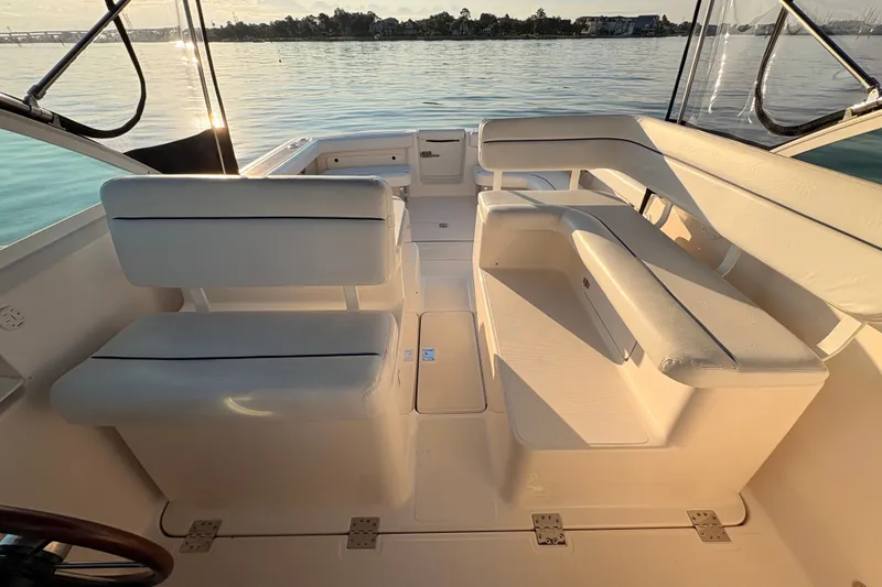 Slide: The Image of 2003 Tiara Yachts 2900 Coronet interior with white seating, overlooking calm waters. - 46