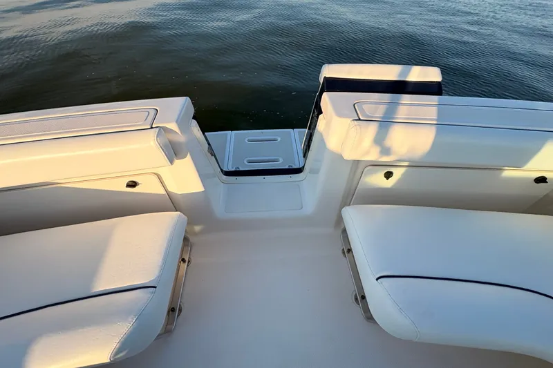 Slide: The Image of 2003 Tiara Yachts 2900 Coronet boat interior with white seating and water view. - 32