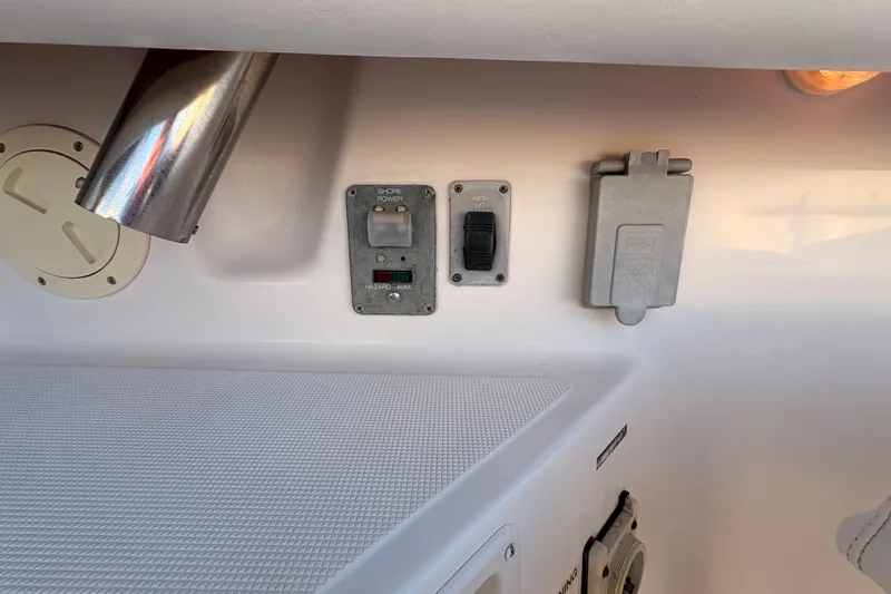 Slide: The Image of Control panel on a 2003 Tiara Yachts 2900 Coronet, featuring shore power and hatch lift switches. - 36