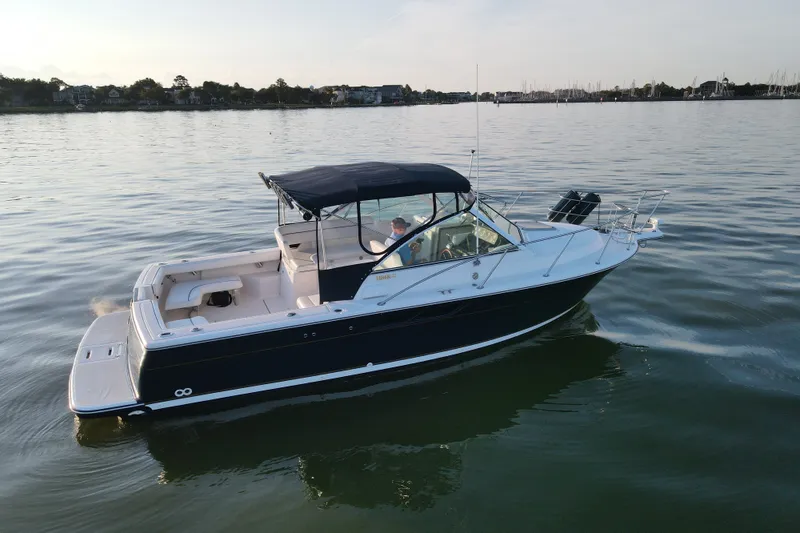 Slide: The Image of 2003 Tiara Yachts 2900 Coronet cruising on calm waters at sunset. - 3