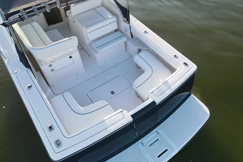 Slide: The Image of 2003 Tiara Yachts 2900 Coronet boat interior with white seating and spacious deck. - 22