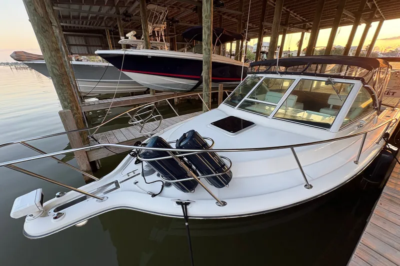 Slide: The Image of 2003 Tiara Yachts 2900 Coronet docked in a marina at sunset. - 57