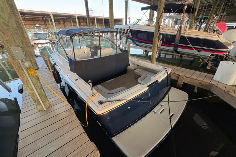 Slide: The Image of 2003 Tiara Yachts 2900 Coronet docked in a marina, showcasing sleek design and spacious deck. - 58