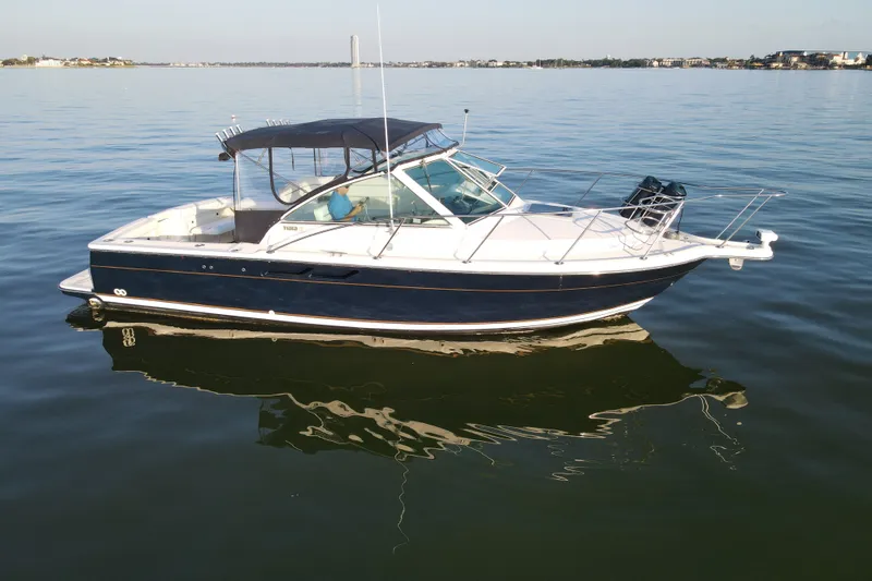 Slide: The Image of 2003 Tiara Yachts 2900 Coronet on calm water, showcasing sleek design and elegance. - 17
