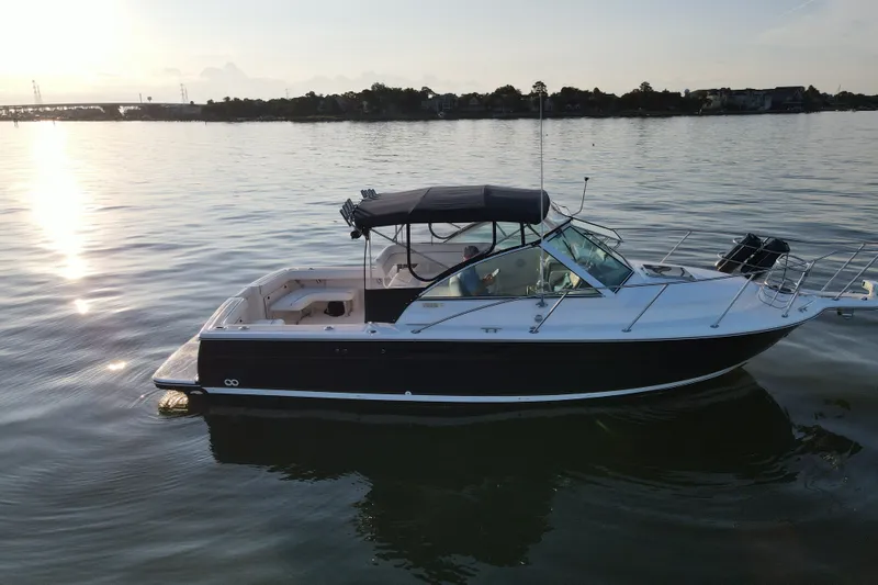 Slide: The Image of 2003 Tiara Yachts 2900 Coronet cruising on calm waters at sunset. - 4