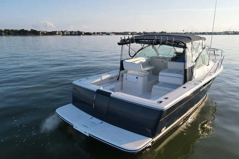 Slide: The Image of 2003 Tiara Yachts 2900 Coronet cruising on calm waters under a clear sky. - 19
