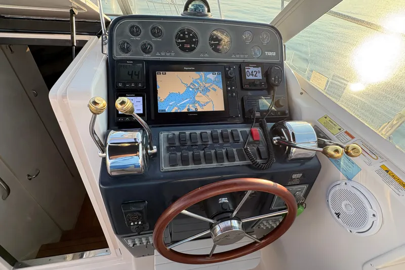 Slide: The Image of Helm of 2003 Tiara Yachts 2900 Coronet with navigation instruments and wooden steering wheel. - 55