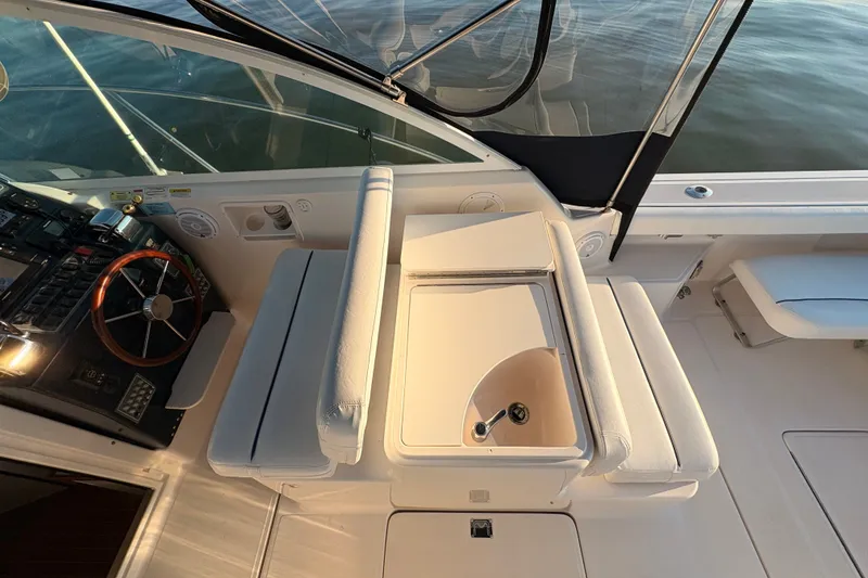 Slide: The Image of 2003 Tiara Yachts 2900 Coronet cockpit with steering wheel and seating area. - 45