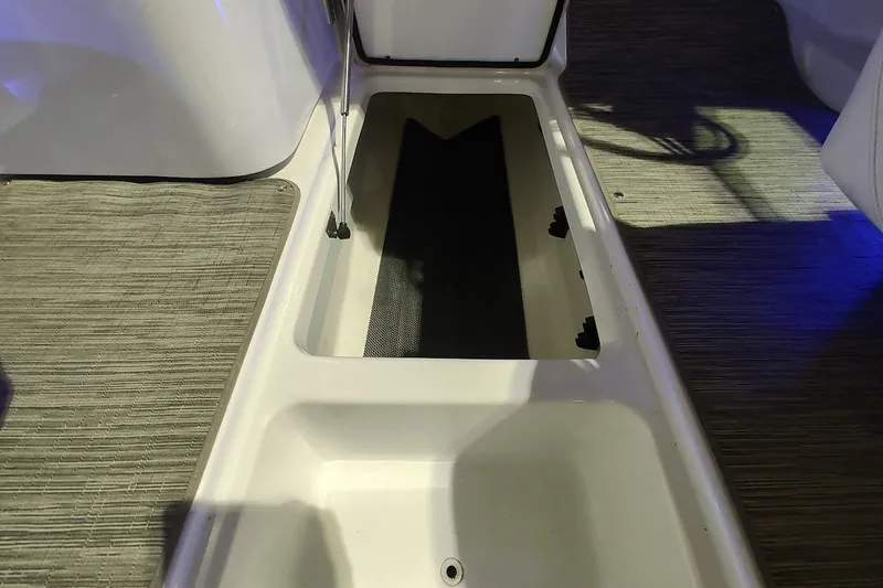Slide: The Image of 2020 Four Winns HD220 boat interior storage compartment with carpeted flooring. - 16