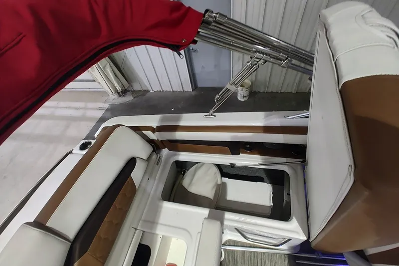Slide: The Image of 2020 Four Winns HD220 boat interior with red canopy and white-brown seating. - 22