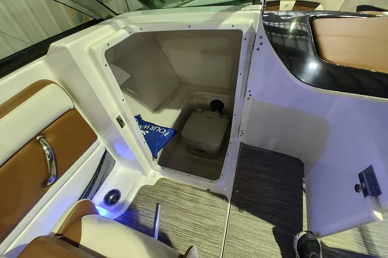 Slide: The Image of 2020 Four Winns HD220 boat interior with storage compartment and seating area. - 14