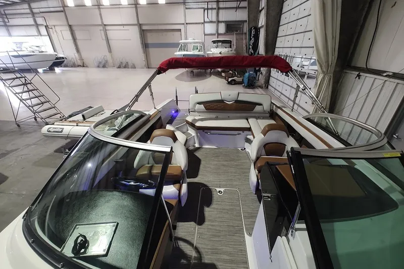 Slide: The Image of 2020 Four Winns HD220 boat interior in a spacious warehouse setting. - 20