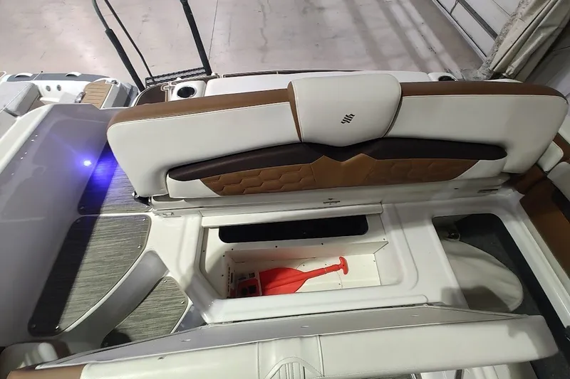 Slide: The Image of 2020 Four Winns HD220 boat interior with storage compartment and seating. - 21