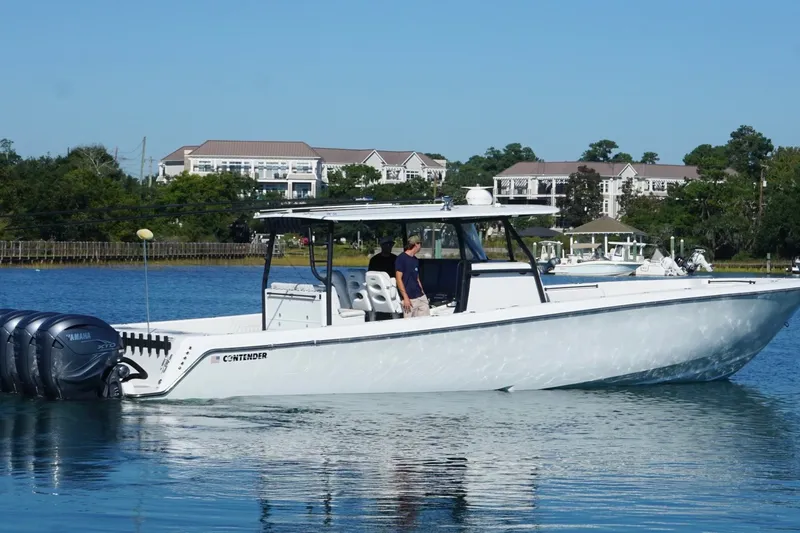 Slide: The Image of 2023 Contender 44 ST boat with Yamaha engines on a calm waterway. - 7