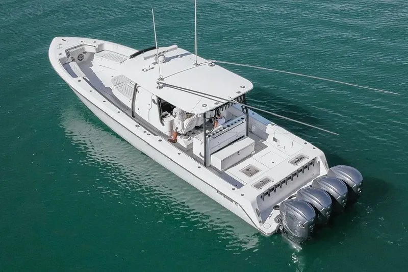 Slide: The Image of 2023 Contender 44 ST boat with four engines on clear water. - 10