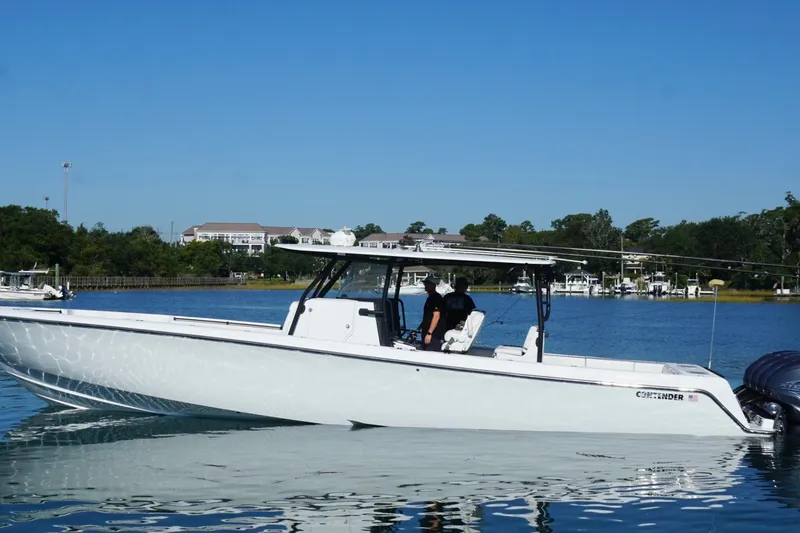 Slide: The Image of 2023 Contender 44 ST boat on calm water, with clear blue sky background. - 15