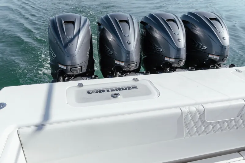 Slide: The Image of Four powerful outboard engines on a 2023 Contender 44 ST boat, cruising on water. - 22
