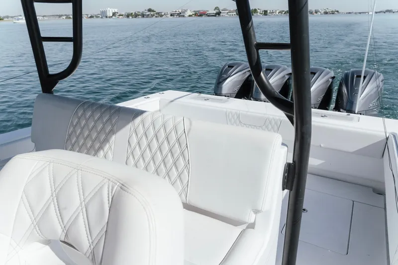 Slide: The Image of 2023 Contender 44 ST boat interior with luxurious seating and powerful outboard engines. - 26
