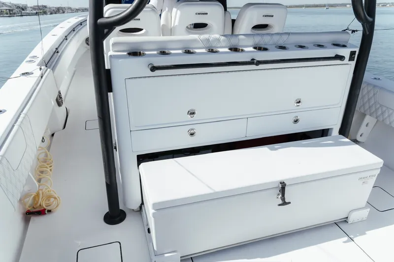 Slide: The Image of 2023 Contender 44 ST boat interior with storage compartments and seating. - 23