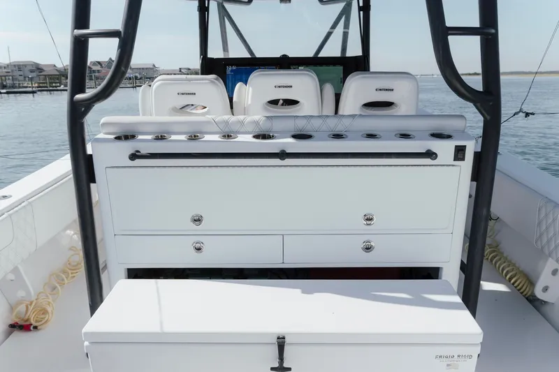 Slide: The Image of 2023 Contender 44 ST boat interior with seating and storage, docked on calm water. - 18