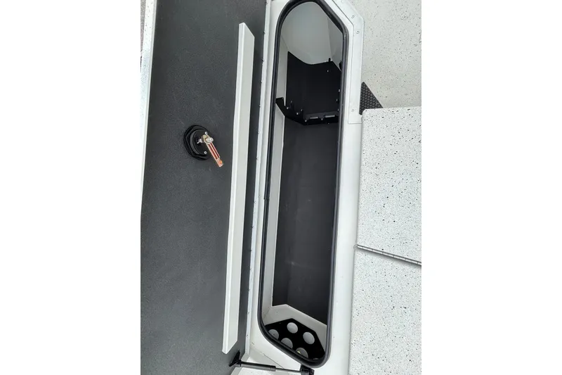 Slide: The Image of Open storage compartment in 2027 Ranger RB200 boat, featuring sleek design and secure latch. - 17