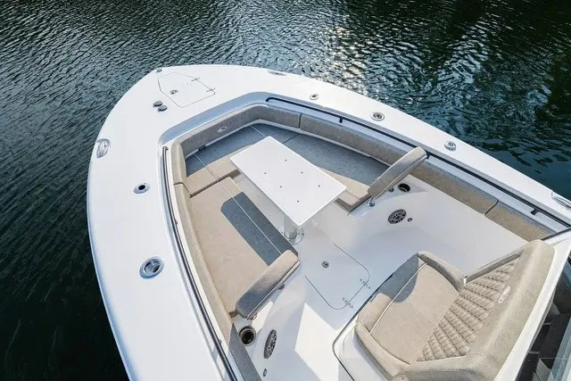 Slide: The Image of The image shows the bow of a 2027 Sea Hunt Gamefish 25 boat with seating and a table. - 17