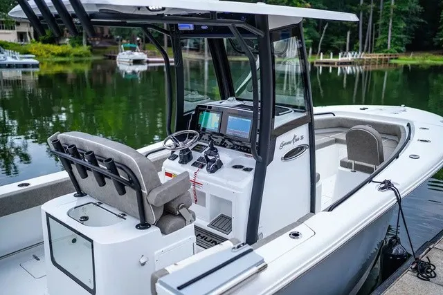 Slide: The Image of A modern sport fishing boat with sleek console and comfortable seating, on a tranquil lake. - 6