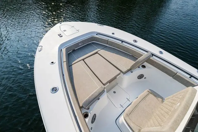 Slide: The Image of The image shows the bow of a 2027 Sea Hunt Gamefish 25 boat with beige cushions. - 18