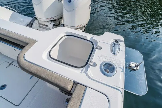 Slide: The Image of The image shows the deck of a Sea Hunt Gamefish 25 boat with a built-in sink and storage. - 12