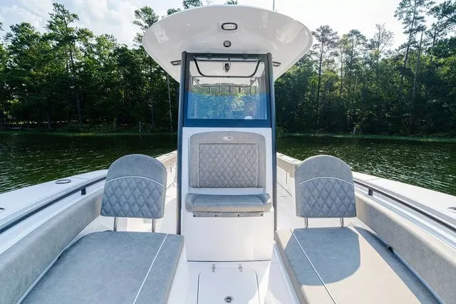 Slide: The Image of The image shows the cockpit of a 2027 Sea Hunt Gamefish 25 boat with gray upholstery. - 15
