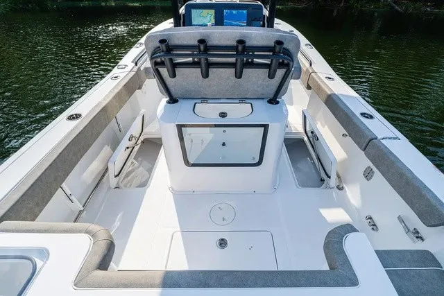 Slide: The Image of The image shows the cockpit of a Sea Hunt Gamefish 25 boat. It features cushioned seats and rod holders. - 9