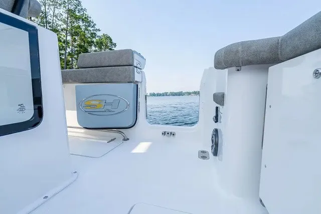 Slide: The Image of The image shows the stern of a 2027 Sea Hunt Gamefish 25 boat with gray upholstery. - 10