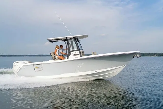 Slide: The Image of A 2027 Sea Hunt Gamefish 25 speeds across the water. Two people are seated in the cockpit. - 4