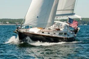 Slide: The Image of Sailing yacht Alden 43, 1993 model, cruising on open water with American flag. - 2