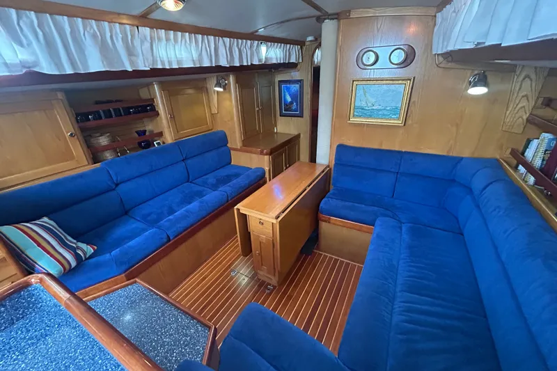 Slide: The Image of Luxurious 1993 Alden 43 yacht interior with blue seating and wooden accents. - 7