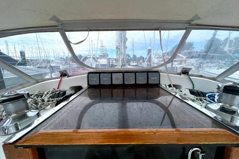 Slide: The Image of Cockpit view of a 1993 Alden 43 sailboat docked at a marina. - 26