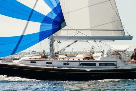 Slide: The Image of Sailing yacht Alden 43 from 1993 with blue and white spinnaker on open water. - 1