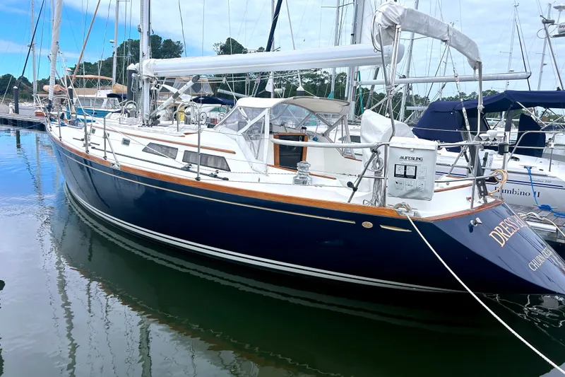 The Image of Sailboat Alden 43, 1993 model, docked in a marina with clear blue skies. - 0