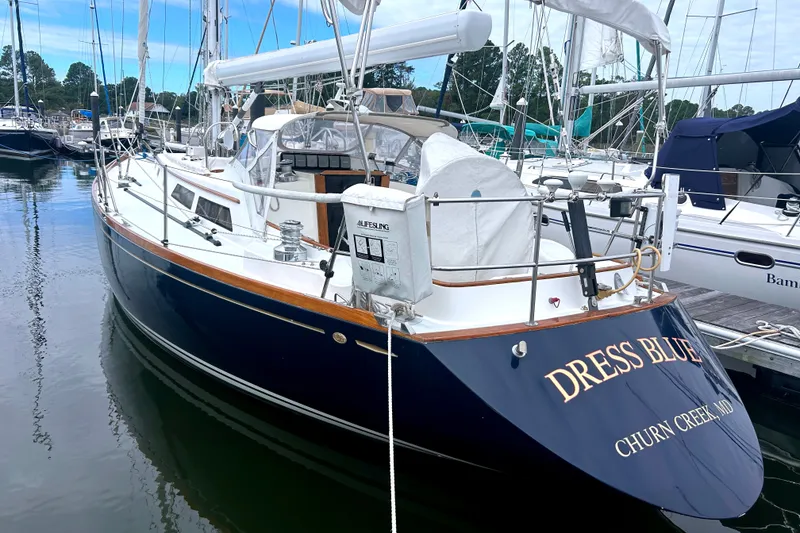 Slide: The Image of Alden 43 sailboat from 1993 named "Dress Blue" docked at a marina. - 3