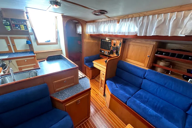 Slide: The Image of Luxurious 1993 Alden 43 yacht interior with blue seating, wood accents, and modern amenities. - 12