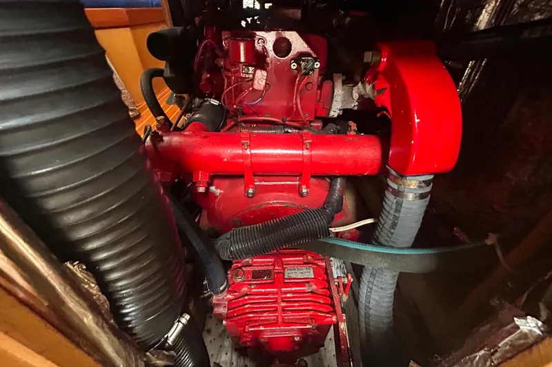Slide: The Image of Red engine inside a 1993 Alden 43 boat, showcasing detailed mechanical components. - 21