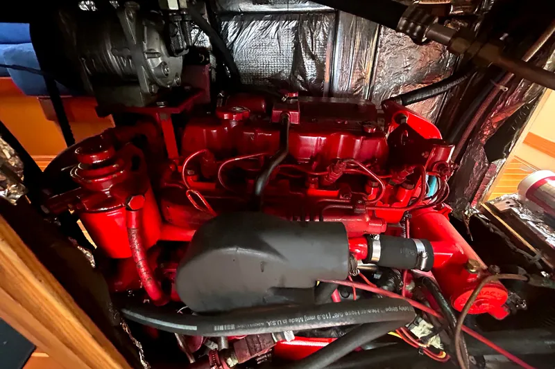 Slide: The Image of Red engine inside a 1993 Alden 43 boat, showcasing intricate mechanical components. - 23