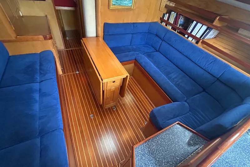 Slide: The Image of Luxurious 1993 Alden 43 yacht interior with blue sofas and wooden flooring. - 9