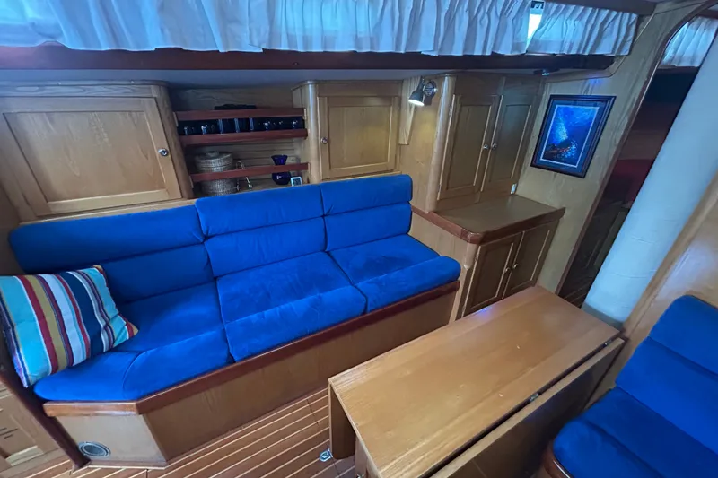 Slide: The Image of Interior of 1993 Alden 43 yacht with blue seating and wooden cabinetry. - 10