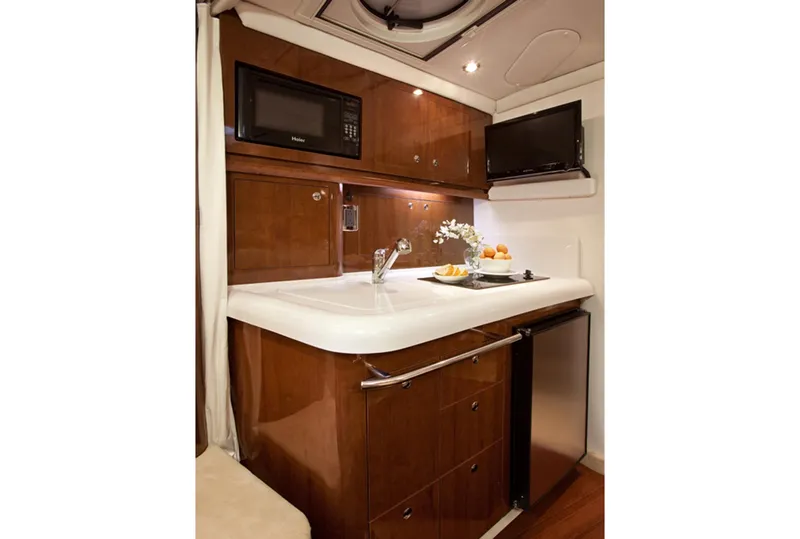 Slide: The Image of Manufacturer Provided Image: 2016 Four Winns V335 yacht kitchenette with microwave, sink, and mini-fridge. - 10