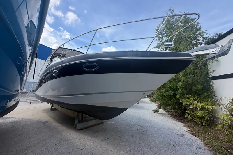The Image of 2016 Four Winns V335 boat on dry dock, side view with clear sky background. - 0