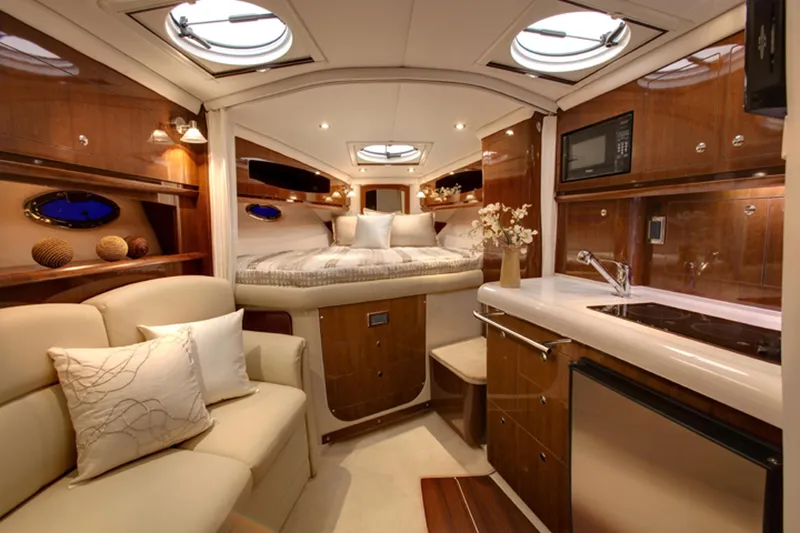 Slide: The Image of Manufacturer Provided Image: Luxurious interior of 2016 Four Winns V335 yacht with bed, sofa, and kitchenette. - 7