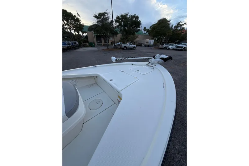 Slide: The Image of 2025 Mako 18 LTS boat parked outdoors, showcasing sleek design and spacious deck. - 6